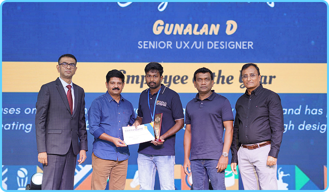 Gunalan receiving the Employee of the Year award on stage at SPAN Technology Services